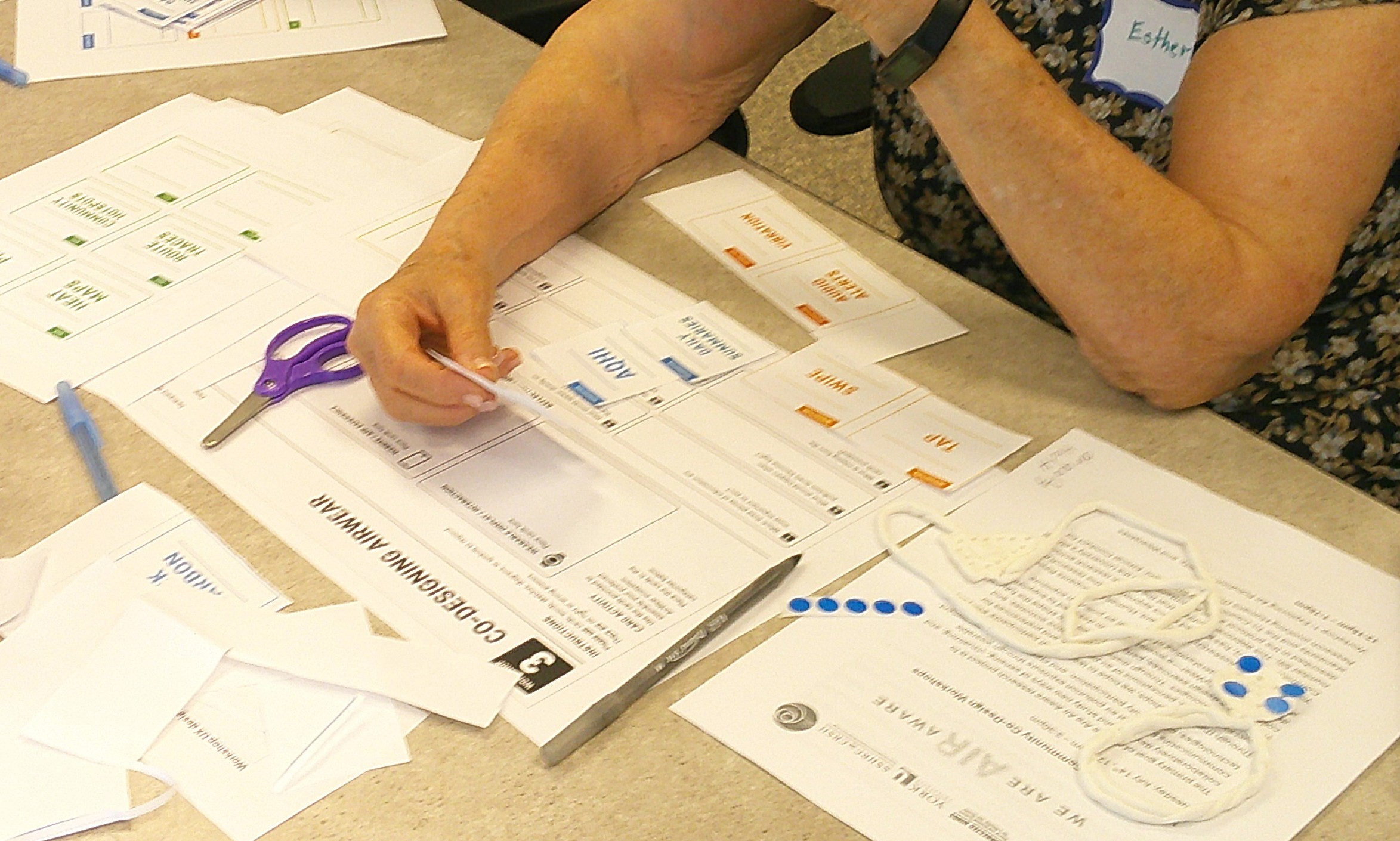 Participant arranging interface and information cards during an AirWear co-design activity