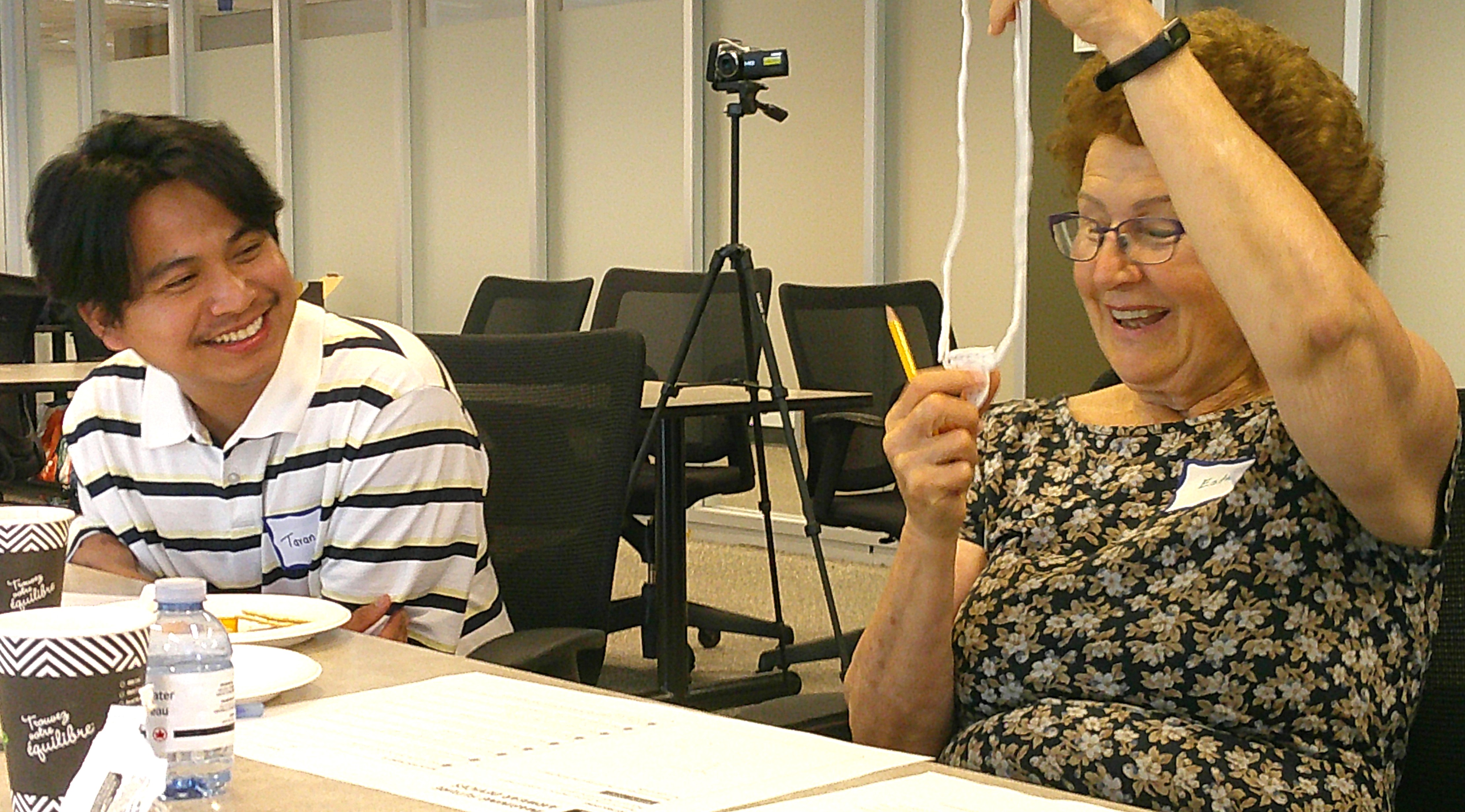 Two workshop participants laughing together while discussing wearable design ideas